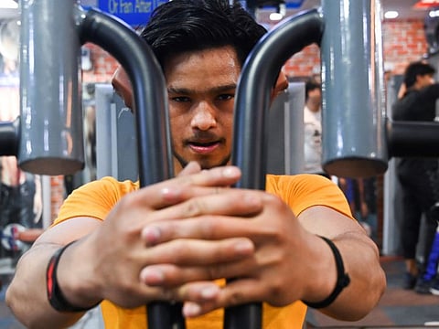In this picture taken on March 19, 2020, a patron exercises in a gym in New Delhi. While top gym chains in India are shuttered over the coronavirus pandemic, many workout dens are defying government orders of a lockdown by staying open for their muscle-bound customers. India, which has reported 10 deaths from around 500 virus cases, staged a one day curfew on March 22 to test its pandemic defences. Authorities then ordered draconian new restrictions on movement. - TO GO WITH 'Health-virus-India-IND-bodybuilding, FOCUS' by Fasial KAMAL
 / AFP / Sajjad HUSSAIN / TO GO WITH 'Health-virus-India-IND-bodybuilding, FOCUS' by Fasial KAMAL
