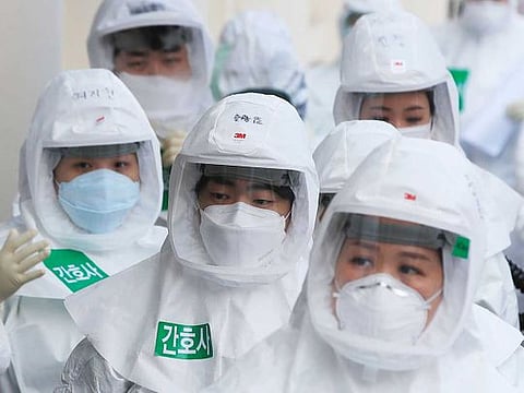 Medical staff members arrive for a duty shift at Dongsan Hospital in Daegu, South Korea, on Tuesday, March 24, 2020.