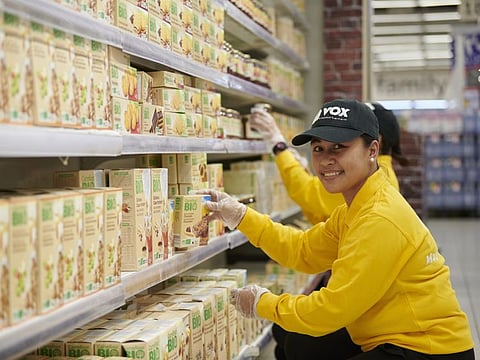 Merly Ann Alerge, Customer Service Officer at VOX Cinemas replenishes stock at Carrefour