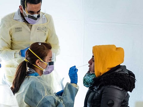 Doctors test people with flu-like symptoms for coronavirus in set-up tents to triage possible COVID-19 patients in the US