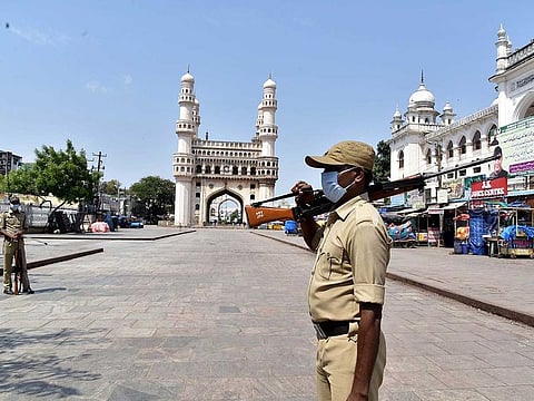 Armed security personnel stand guard at Charminar during Telangana shutdown to prevent the spread of COVID-19 in Hyderabad on Tuesday. 