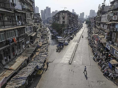 Pedestrians walk along near-empty roads during a lockdown imposed due to the coronavirus in Mumbai, India, on Wednesday, March 25, 2020.