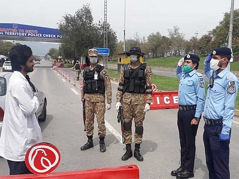 Policemen in Islamabad salute a doctor as part of the campaign to thank the medical professionals for being the frontline soldiers in fight against coronavirus. 
