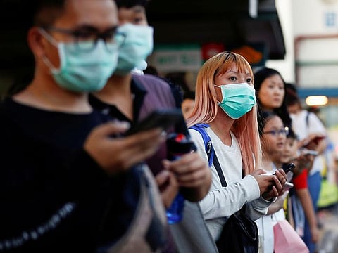 Commuters wait for a transport to leave the Woodlands Causeway across to Singapore from Johor, hours before Malaysia imposes a lockdown on travel due to the coronavirus outbreak March 17, 2020. 