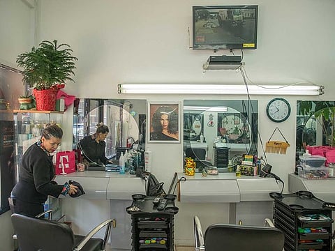 File picture:  A Condition Beauty Salon worker sweeps the floor while the salon is vacant in New York, March 18, 2019. Picture used for illustrative purpose only.