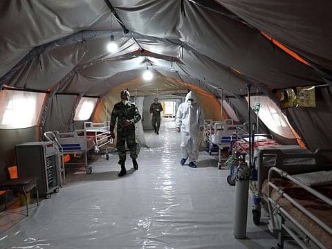 Iranian army soldiers work in a temporary 2,000-bed hospital for COVID-19 coronavirus patients set up by the army at the international exhibition centre in northern Tehran on  March 26.