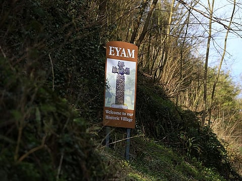 A sign welcomes people to the village of Eyam in Derbyshire, northern England on March 23, 2020.  In the 17th century, the inhabitants of Eyam got rid of the plague by placing themselves in quarantine. In recent more days, in the midst of the novel coronavirus pandemic, this village in central England has seen red in the face of an influx of visitors defying health recommendations.