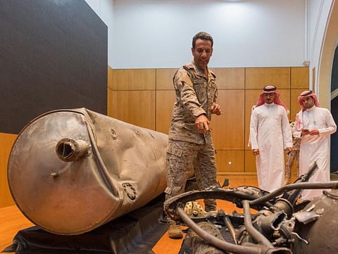 A handout photo taken and released by the Saudi Press Agency on March 29 shows Saudi-led coalition spokesman Colonel Turki Al Malki giving explanations during a press conference, in Riyadh, on the displayed missile's debris fired on March 28 by Yemen's Al Houthi militia.