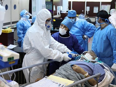 Emergency medical staff and nurses wearing protective suits, help while transferring a patient with coronavirus disease to Masih Daneshvari Hospital, in Tehran on March 30.