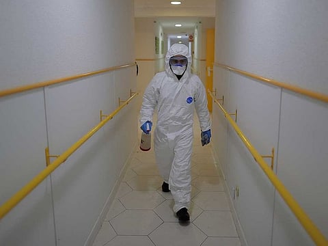 A member of the UME (Emergency Army Unit)  wearing a protective suit to protect against coronavirus disinfects a nursing home in Madrid, Spain, on Tuesday, March 31, 2020.