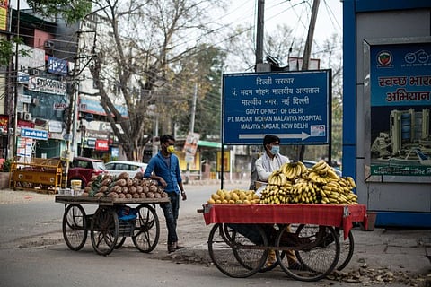 Fruit vendors on a street corner during Prime Minister Narendra Modi’s lockdown order for India’s 1.3 billion citizens to fight the spread of coronavirus, in New Delhi, India, March 26, 2020. Although selling food is deemed necessary and permissible during the lockdown, vendors are finding fewer customers.
