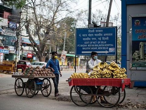 Fruit vendors on a street corner during Prime Minister Narendra Modi’s lockdown order for India’s 1.3 billion citizens to fight the spread of coronavirus, in New Delhi, India, March 26, 2020. Although selling food is deemed necessary and permissible during the lockdown, vendors are finding fewer customers.