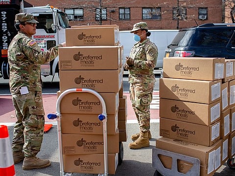 National Guard members coordinate food donations in front of the Thomas Jefferson Recreation Center in New York, Tuesday, March 31, 2020, in the wake of the coronavirus pandemic.