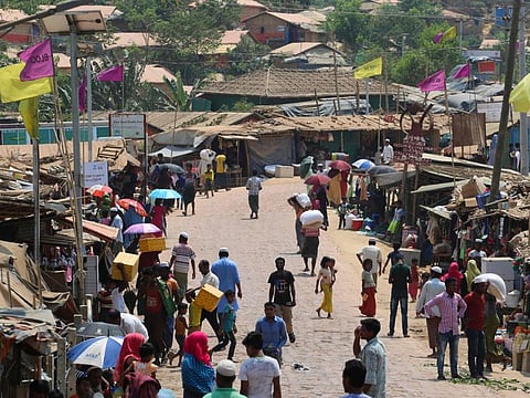 Rohingya refugees, without wearing any mask or any other safety gear as a preventive measure against coronavirus, gather along a market area in Kutupalong refugee camp in Ukhia  