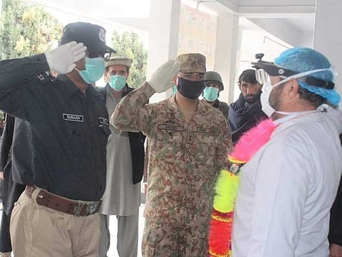 Security personnel salute a doctor in Pakistan for being the frontline soldier in fight against coronavirus.