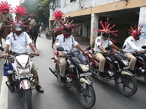 Indian policemen wearing virus themed helmets ride on motorcycles during an awareness rally aimed at preventing the spread of new coronavirus in Hyderabad, India, Thursday, April 2, 2020.