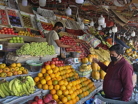 Indians wearing masks buy fruits during a lockdown to prevent the spread of new coronavirus in New Delhi, India, Thursday, April 2, 2020. 