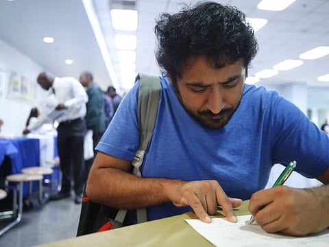 AFP
A job seeker  fills out an application at a career fair hosted by the Los Angeles Mission.  The  March report was the worst job loss since March 2009.