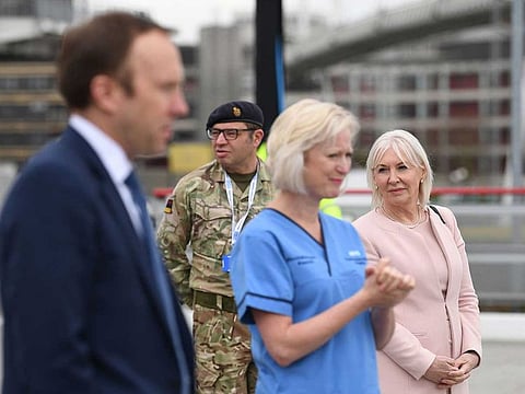 Health minister Nadine Dorries (R) and Britain's Health Secretary Matt Hancock (L) attend the opening of the "NHS Nightingale" field hospital, created at the ExCeL London exhibition centre, in London on April 3, 2020, to help with the novel coronavirus COVID-19 pandemic.  The new state-run National Health Service (NHS) hospital, named after trailblazing 19th-century nurse Florence Nightingale, has been built in just nine days. 