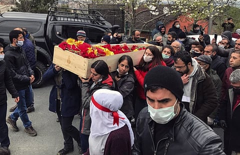 Mourners carry the open coffin of Helin Bolek, a member of a popular folk music group that is banned in Turkey, during the funeral procession in Istanbul on April 3.