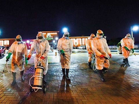 Municipality workers disinfect Nasiriya area in Sharjah on March 2020, to prevent the spread of the COVID-19 coronavirus. 