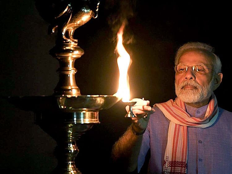 Prime Minister Narendra Modi lights a lamp 