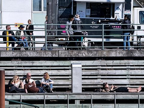 People relax in the sun, as the spread of the coronavirus disease (COVID-19) continues,  in Malmo, Sweden earlier this month
