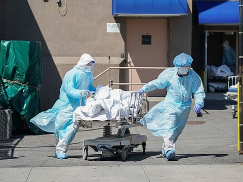 Bodies are moved to a refrigeration truck serving as a temporary morgue at Wyckoff Hospital in the Borough of Brooklyn on April 6, 2020 in New York. 