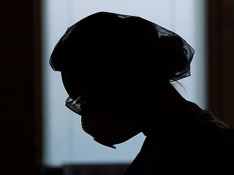 A healthcare worker silhouetted against the window, during a shift at an intensive care unit (ICU) at the General University Hospital where patients infected with the COVID-19 are treated in Prague, Czech Republic.