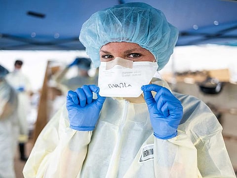 Picture for illustrative purposes: a medical staffer with face mask and PPE 
