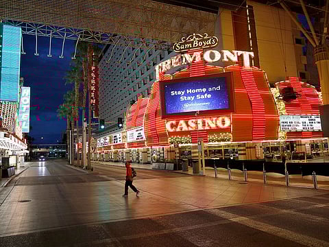 A man walks along a usually busy Fremont Street after casinos were ordered to shut down due to the coronavirus outbreak in Las Vegas.