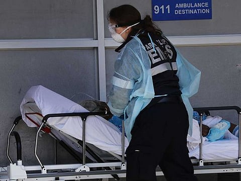 A medical worker attends to a patient at a special coronavirus intake area at Maimonides Medical Centre in the Borough Park neighborhood of the Brooklyn borough of New York City on April 11, 2020. 