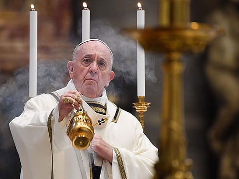 Pope Francis swings a thurible at the start of Easter Sunday Mass behind closed doors at St. Peter's Basilica in The Vatican.   