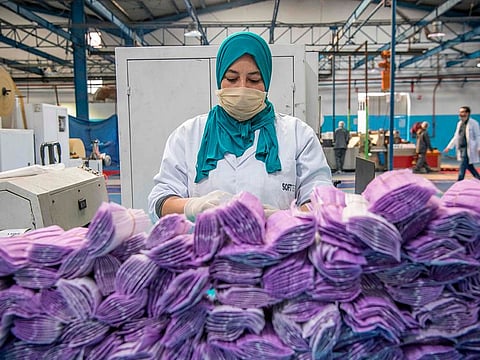 A factory worker packages disposable protective masks along a production line in Morocco's Casablanca on April 10, 2020, as the North African country increases mask production due to the COVID-19 coronavirus pandemic. 