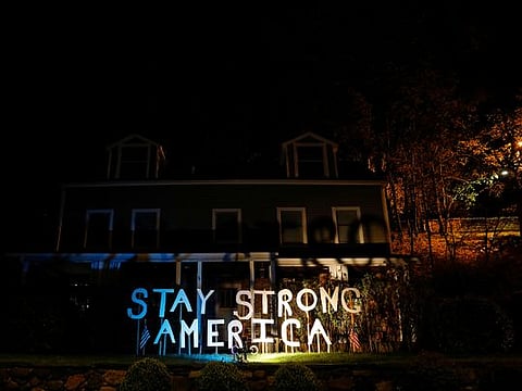 A sign is seen lit outside a house during the outbreak of the coronavirus disease (COVID-19) in the New York City suburb of Piermont, New York, U.S. 