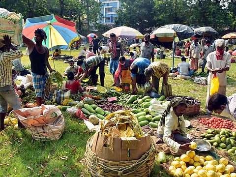 People buying vegetables and other essentials from a makeshift market during the second phase of COVID-19 lockdown in Kolkata on Wednesday. 