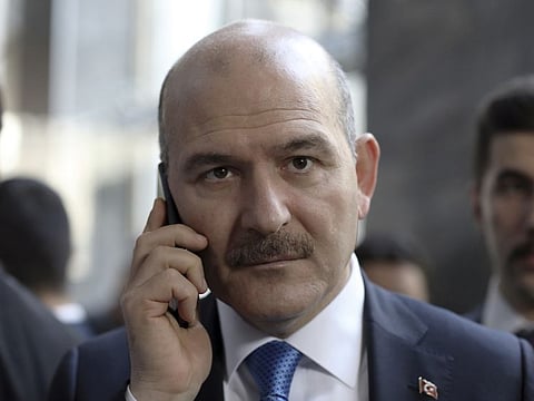 In this file 2019 photo, Turkey's Interior Minister Suleyman Soylu speaks on the phone in Ankara. President Recep Tayyip Erdogan rejected earlyApril 13, the resignation of Soylu who took responsibility for a poorly timed announcement of a weekend curfew that prompted thousands of people to rush into the streets.