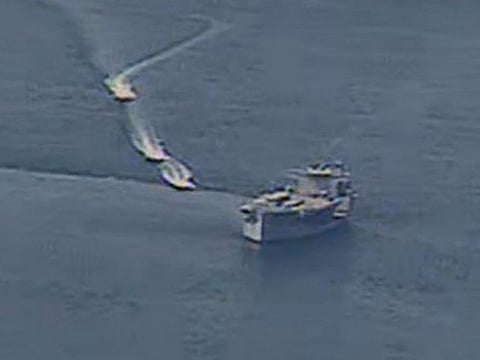 Iranian Islamic Revolutionary Guard vessels near US Navy ships in international waters of the Arabian Gulf. 