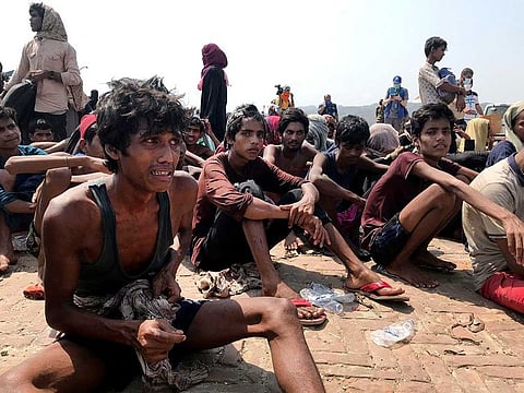 Rohingya refugees react after being rescued in Teknaf near Cox's Bazar, Bangladesh, Thursday, April 16, 2020. Bangladesh's coast guard has rescued 382 starving Rohingya refugees who had been drifting at sea for weeks after failing to reach Malaysia, officials said Thursday. 
