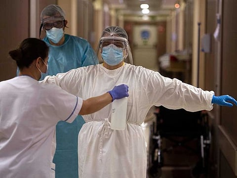 File picture: A healthcare worker is disinfected after attending to COVID-19 coronavirus patients at the CEMTRO private clinic in Madrid on April 17, 2020. 