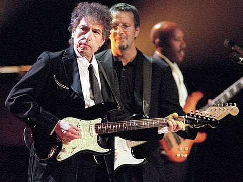 TO GO WITH STORY SLUGGED: BOB DYLAN--FILE--Rock and Roll legends Bob Dylan, left, and Eric Clapton, center, perform for a sold out crowd at New York's Madison Square Garden, in this June 30, 1999, file photo. In his fourty-year career, Dylan has released 43 albums and sold over 50 million recordings. (AP Photo/John Bellissimo/HO)
