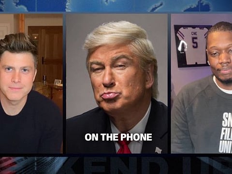 New York: In this screengrab provided by NBC, from left to right, anchor Colin Jost, Alec Baldwin as Donald Trump, and Michael Che perform the Weekend Update during "Saturday Night Live" which aired on Saturday, April 11, 2020. For the first time in its lengthy history, "Saturday Night Live" held an all-quarantine version, with stars delivering taped material primarily from their homes.    AP/PTI(AP13-04-2020_000003B)