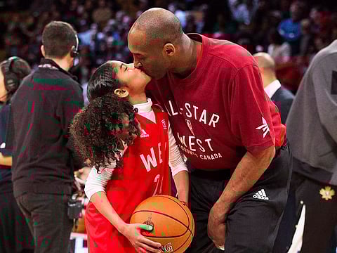 Kobe Bryant kisses his daughter Gianna