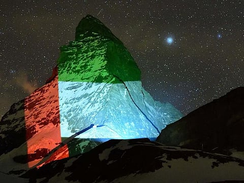 The colours of the UAE flag are projected on to the Matternhorn on Friday night. 