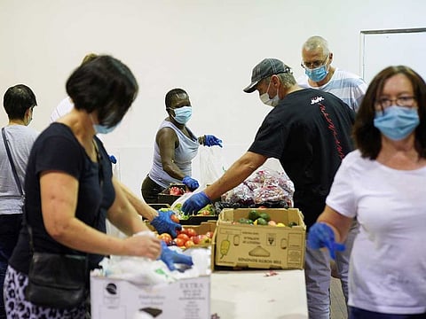 Masked church volunteers organise food donations before distributing them to those in need, an approved essential service during the spread of the coronavirus disease (COVID-19), at One1Seven evangelical Anglican church in Sydney, Australia, April 17, 2020.