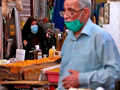 People shop in preparation for the Muslim fasting month of Ramadan, in Baghdad, Iraq, Tuesday, April 21, 2020. Ramadan begins with the new moon later this week and Muslims all around the world are trying to work out how to maintain the many cherished rituals of Islam's holiest month during the coronavirus pandemic.