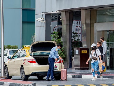 A Taxi driver wearing mask on Sheikh Zayed service road. Dubai. 