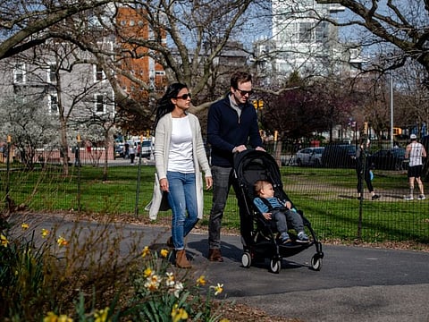 Neena Budhraja, a physician assistant in the emergency room at Woodhull Medical and Mental Health Center in Brooklyn, and Adam Hill, an emergency room doctor at Elmhurst Hospital Center in Queens, with their 18-month-old son Nolan in McCarren Park in New York on April 7, 2020. The coronavirus pandemic is putting unimagined strain on medical workers, exposing them to dangers and emotional stress unlike anything they have ever experienced.