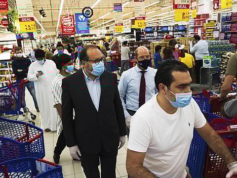 Majid Al Futtaim CEO Alain Bejjani, left, and store manager Arnaud Bouf, right, walk through heavy traffic during the coronavirus pandemic in the world's busiest Carrefour supermarket in Mall of the Emirates in Dubai.