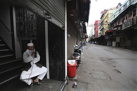A Muslim priest asks people to take precautions against coronavirus and remain inside their house during a lockdown to control the new virus spread, in New Delhi.